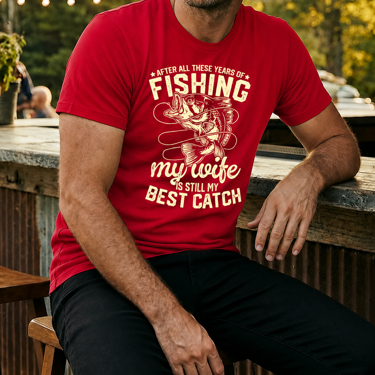 Fishing themed red t-shirt with quote "After all of these years of fishing my wife is still my best catch" printed on a comfortable casual tee