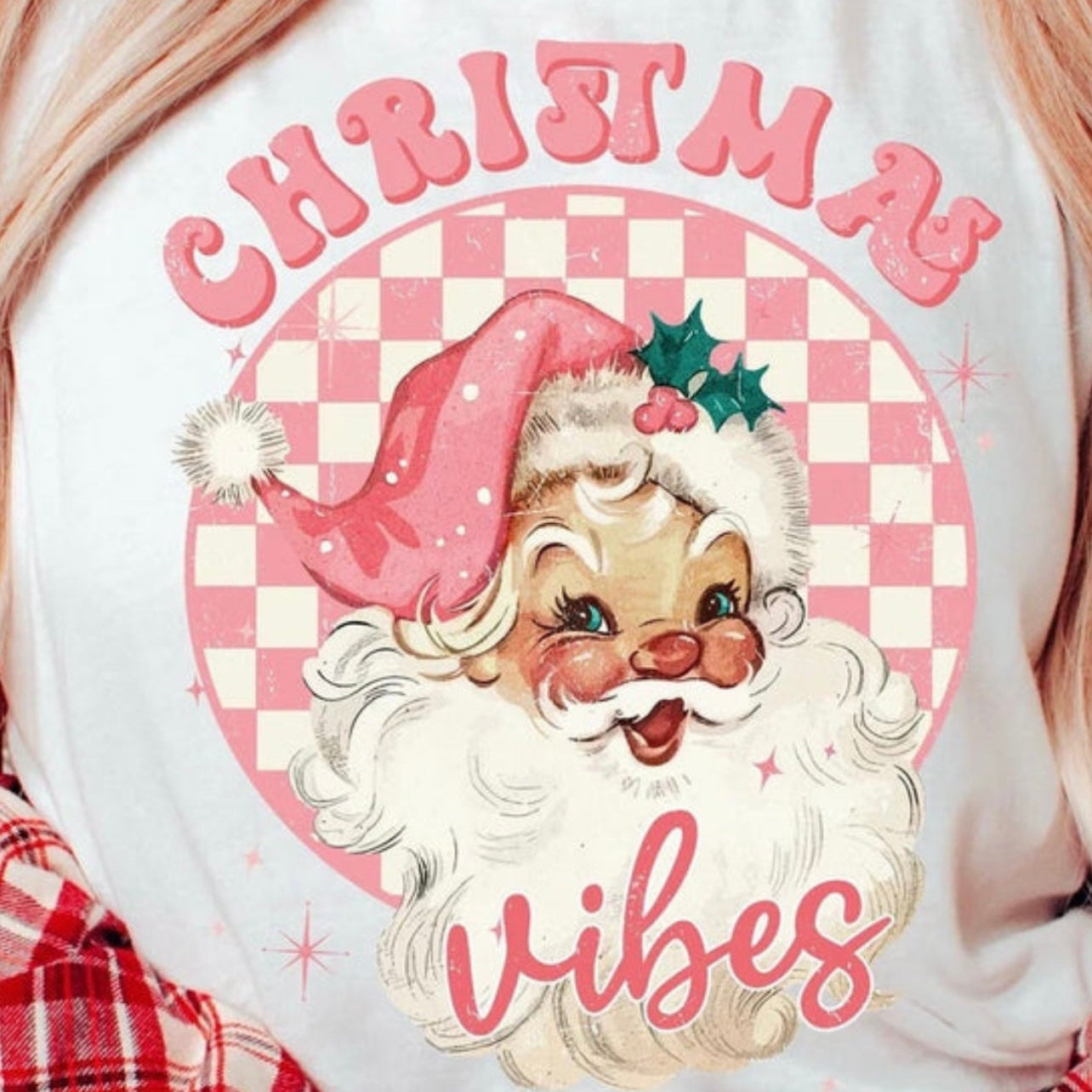 White sweatshirt with a vintage Santa Claus design and 'Christmas Vibes' text on a checkered background.