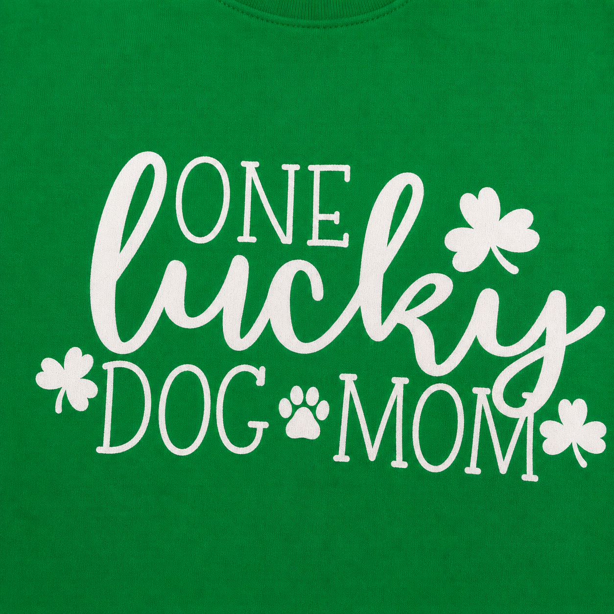 'One lucky dog mom' text and white shamrock designs on a green background