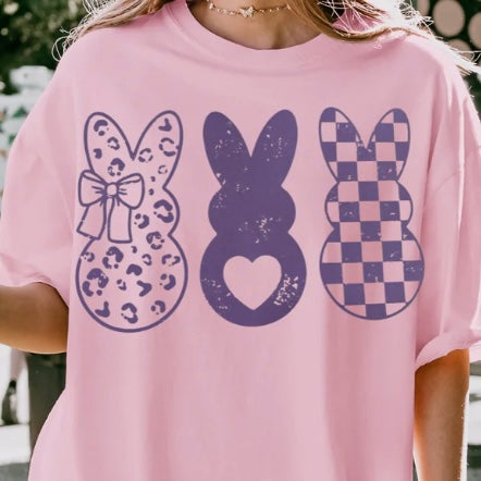 Three purple bunnies graphic t-shirt with heart, checkered, and leopard print bunny