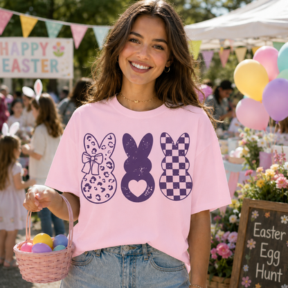 Three purple bunnies on a blossom colored graphic t-shirt with heart, checkered, and leopard print bunny