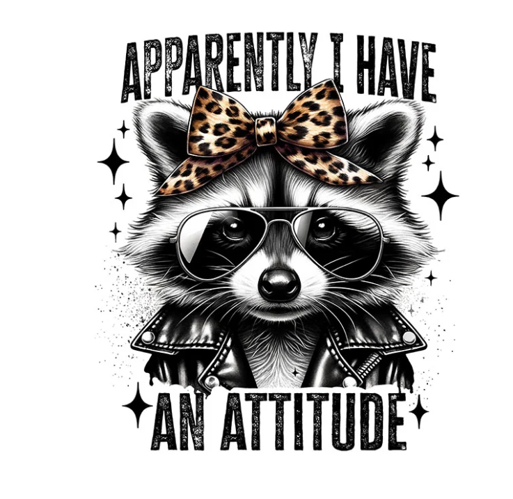 A stylized raccoon illustration wearing black sunglasses, a leopard-print bow, and a black leather jacket, with the text 'APPARENTLY I HAVE AN ATTITUDE' on a white background.