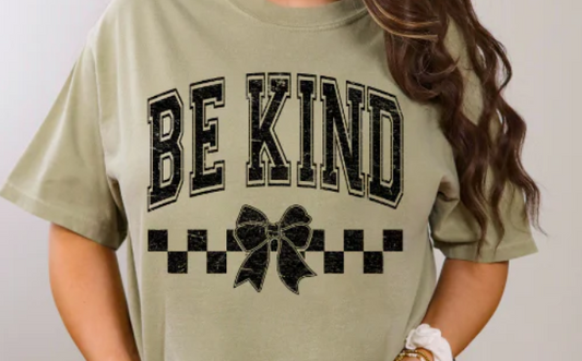 Cute “Be Kind” graphic tee with a checkered bow. Soft, comfy, and perfect for spreading positivity in everyday style.