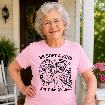 Woman wearing a pink t-shirt with a graphic and text on a porch.