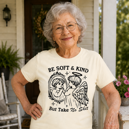 Woman wearing an ivory colored t-shirt with an angel design and text on a porch.