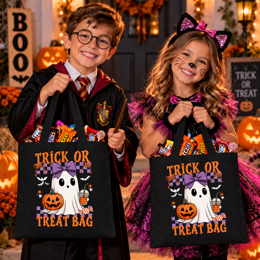 Two children in Halloween costumes holding black 'Trick or Treat Bag' tote bags filled with candy, posed in a festive Halloween-themed room with pumpkins and autumn decorations.