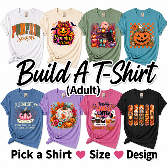 Promotional graphic showing ten adult T-shirt designs in different colors, with large text reading 'Build A T-Shirt (Adult)' and smaller text 'Pick a Shirt', 'Size', and 'Design'. The shirts feature Halloween-themed graphics including pumpkins, ghosts, candy corn, and autumn scenes.