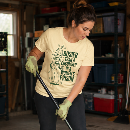 Woman wearing a banana colored t-shirt with a graphic design saying Busier than a cucumber  humorous text cleaning a garage.
