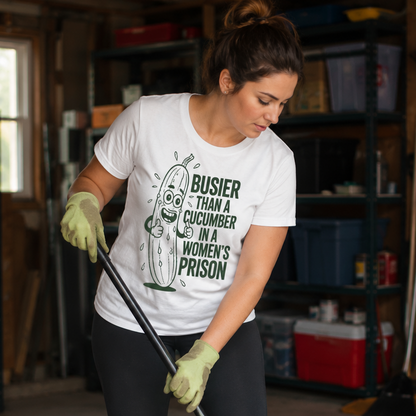 Woman wearing a white t-shirt with a graphic design saying Busier than a cucumber  humorous text cleaning a garage.