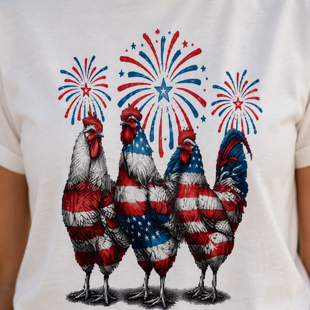 T-shirt with rooster design using American flag colors and fireworks on a white background