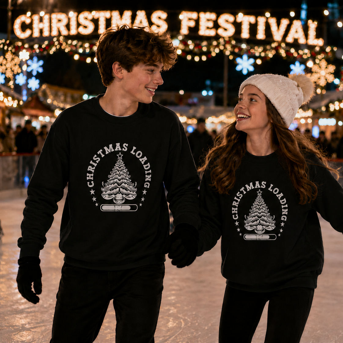 Two people wearing black Christmas-themed sweatshirts at a festive outdoor skating rink.