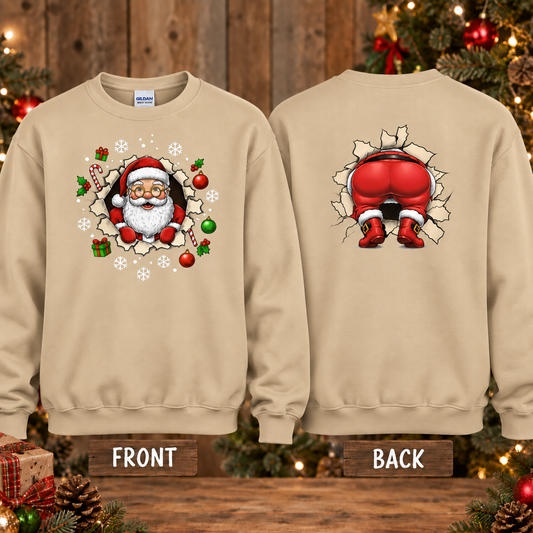 A sand crewneck sweatshirt shown from both front and back. The front features a Christmas graphic of Santa Claus bursting through a hole, surrounded by ornaments and candy canes.