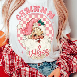 White graphic tee featuring a jolly retro Santa design with festive Christmas vibes.
