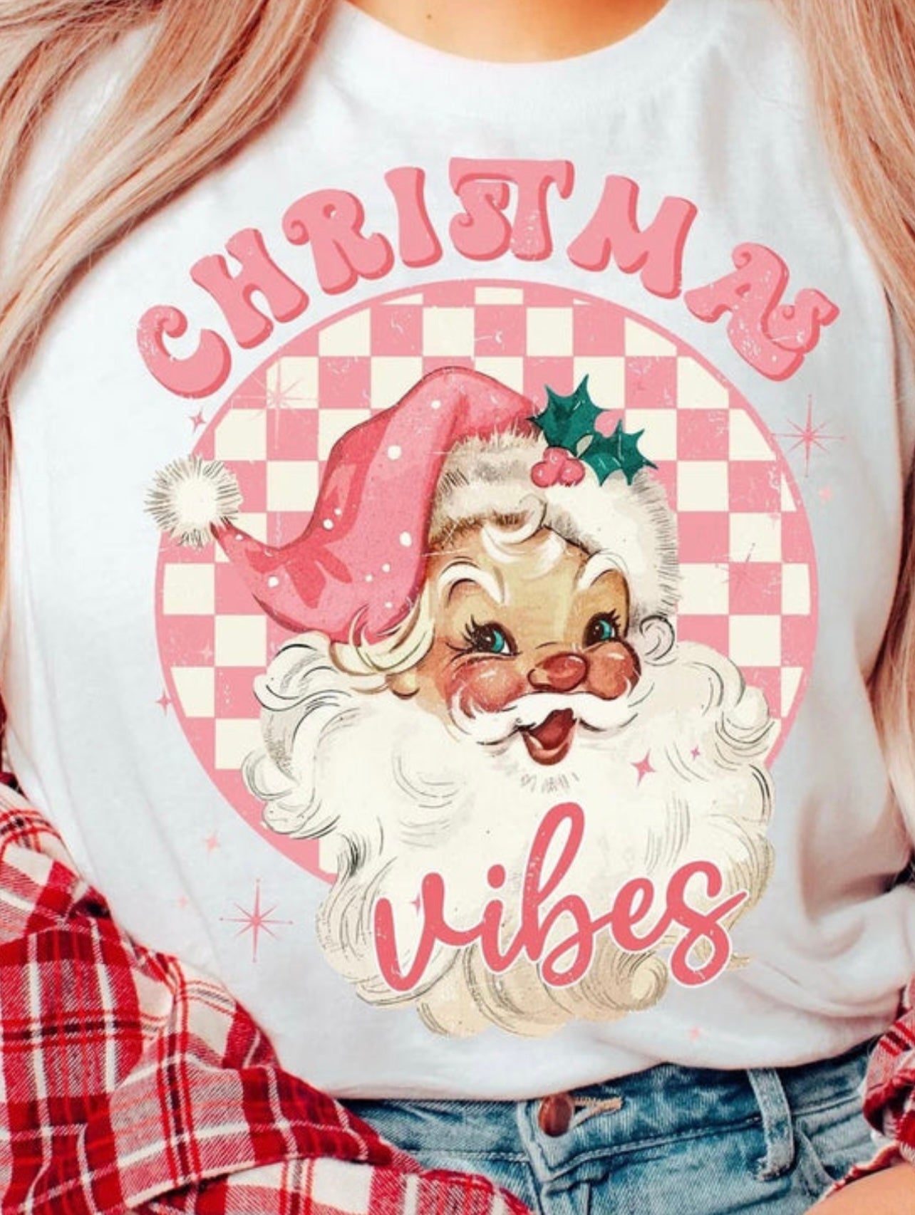 White sweatshirt with a vintage Santa Claus design and 'Christmas Vibes' text on a checkered background.