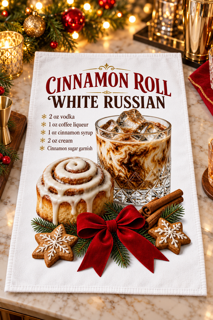 A white kitchen towel featuring a Christmas-themed 'Cinnamon Roll White Russian' recipe print, laid flat on a marble countertop with holiday decorations in the background.