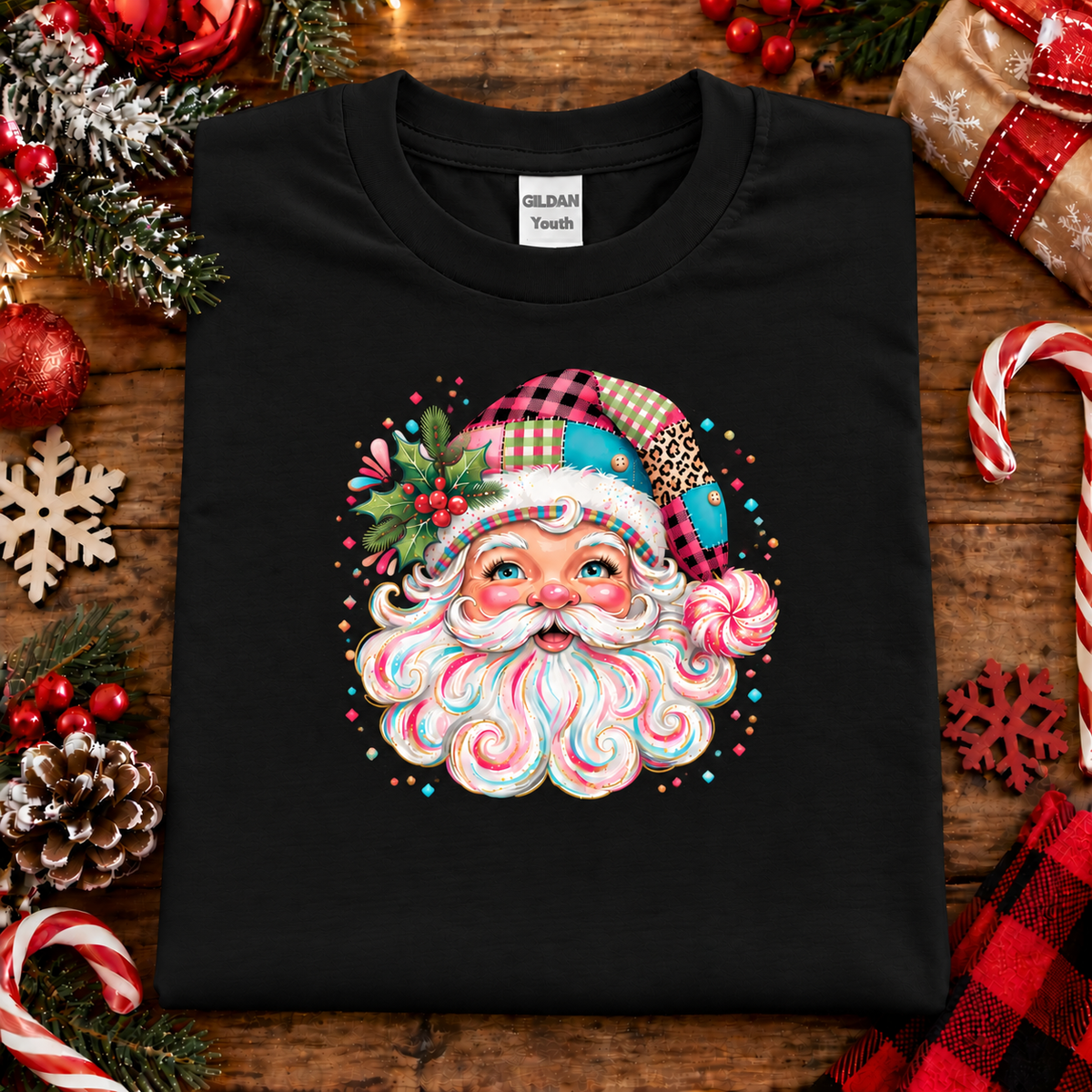 A black Gildan Youth t-shirt featuring a colorful Christmas graphic of a Santa Claus face made from candy swirls, a lollipop, and a plaid hat. 