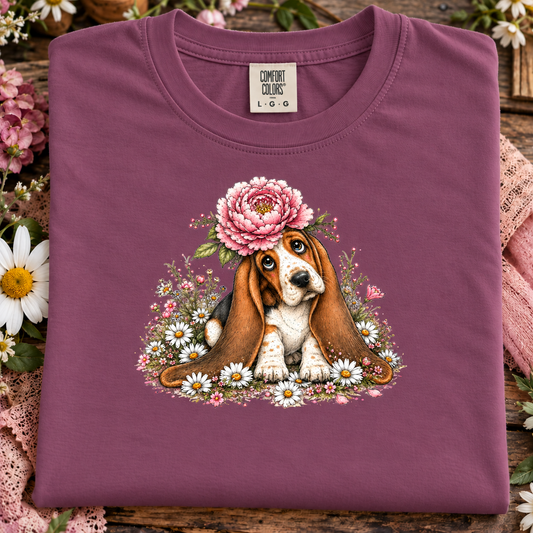 A berry colored t-shirt with a basset hound with flowers graphic.