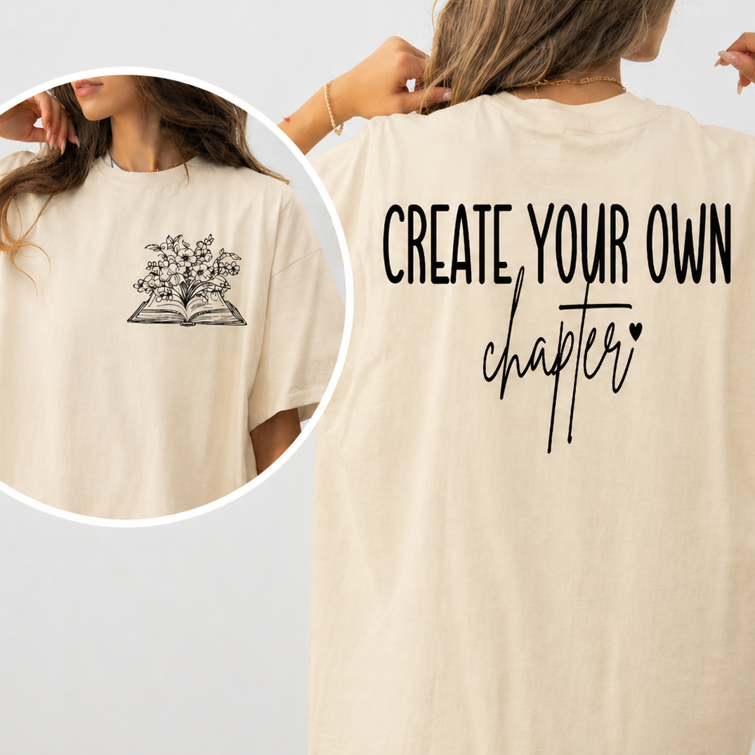 Natural colored  t-shirt with 'Create Your Own Chapter' text and a small graphic on the back.