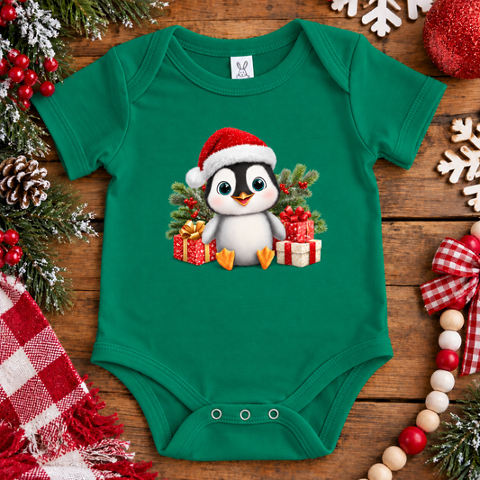 A kelly green onesie with a penquin with presents and a santa hat on graphic