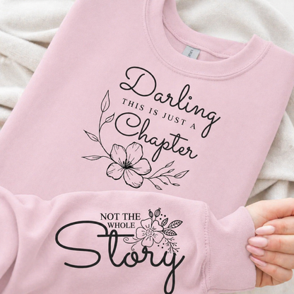Light pink sweatshirt with floral text design on a light background