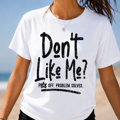 Person wearing a white t-shirt with black text on a beach