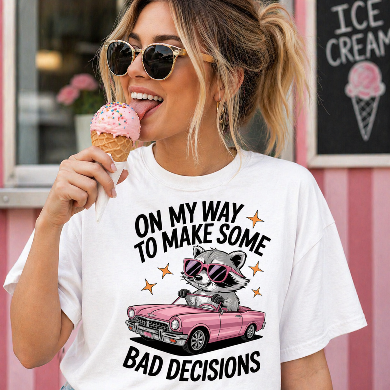 Woman wearing a white t-shirt with a raccoon graphic and text, holding an ice cream cone.