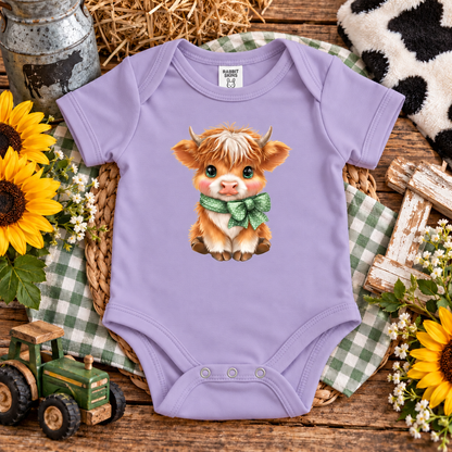 A lavender onesie with a highland cow with a bow graphic onesie