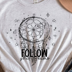 White t-shirt with a dreamcatcher design and 'Follow your dreams' text.