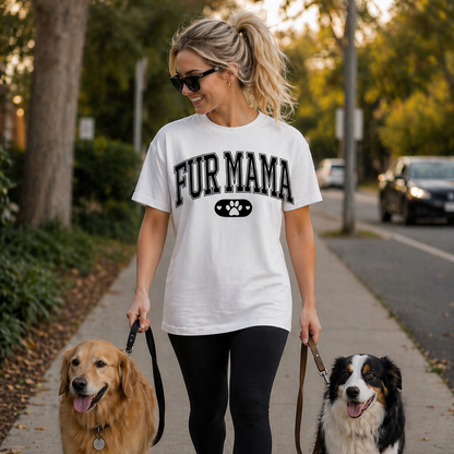 Woman walking two dogs on a sidewalk wearing a 'FUR MAMA' t-shirt.