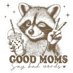 A graphic T-shirt with an illustration of a raccoon holding a beverage and making a peace sign, with the text 'GOOD MOMS Say bad words'.