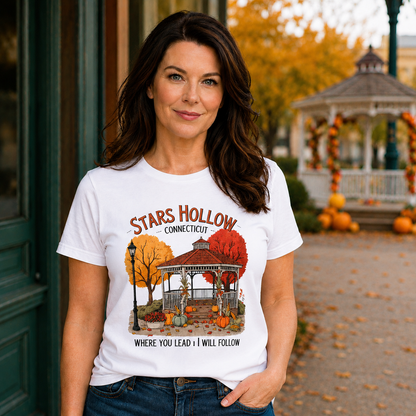 Woman wearing a 'Stars Hollow Connecticut' white t-shirt with a scenic design in an outdoor setting.