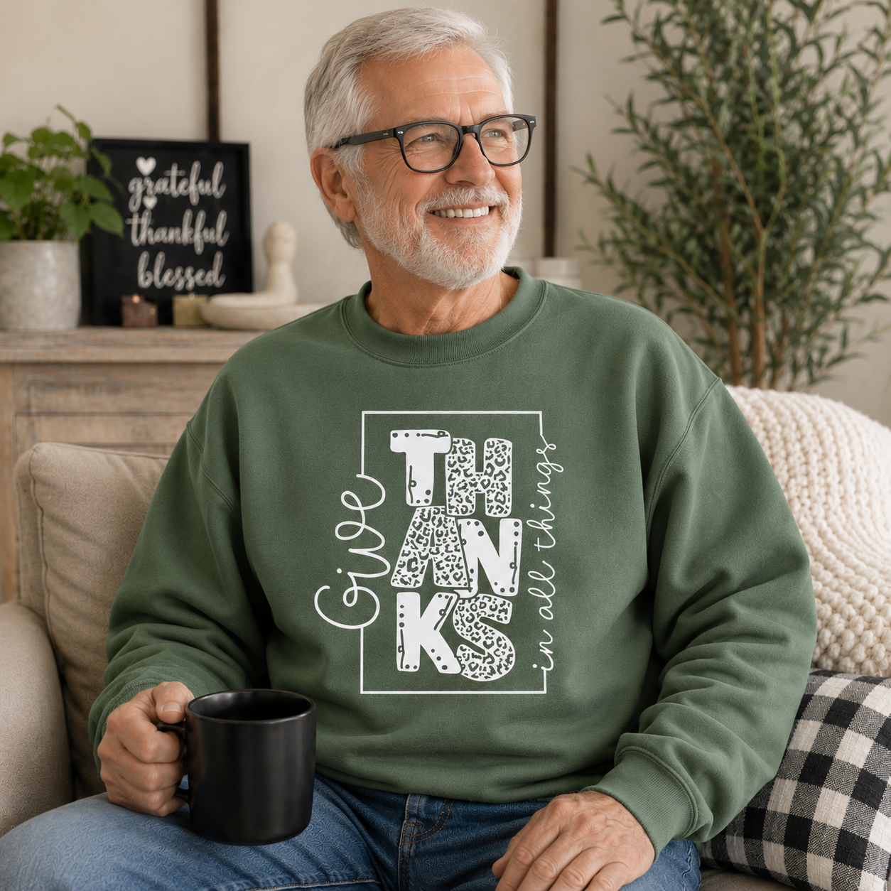 Man wearing a military green colored sweatshirt with text “Give Thanks in All Things” soft, comfy, and perfect for Thanksgiving or everyday fall wear.