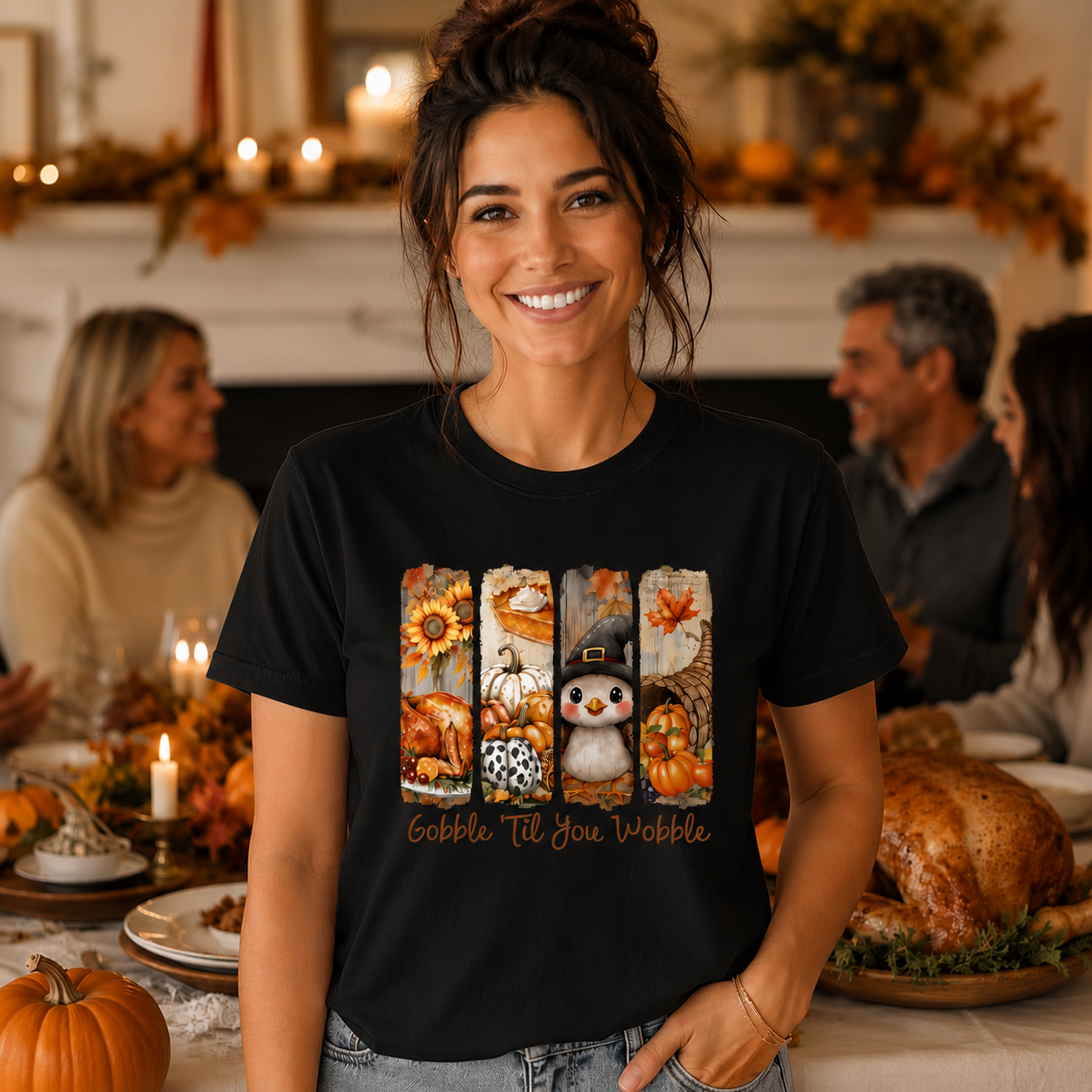 A woman wearing a black graphic t-shirt with a fall harvest design and the text 'Gobble Till You Moggle' stands in front of a blurred Thanksgiving dinner background.