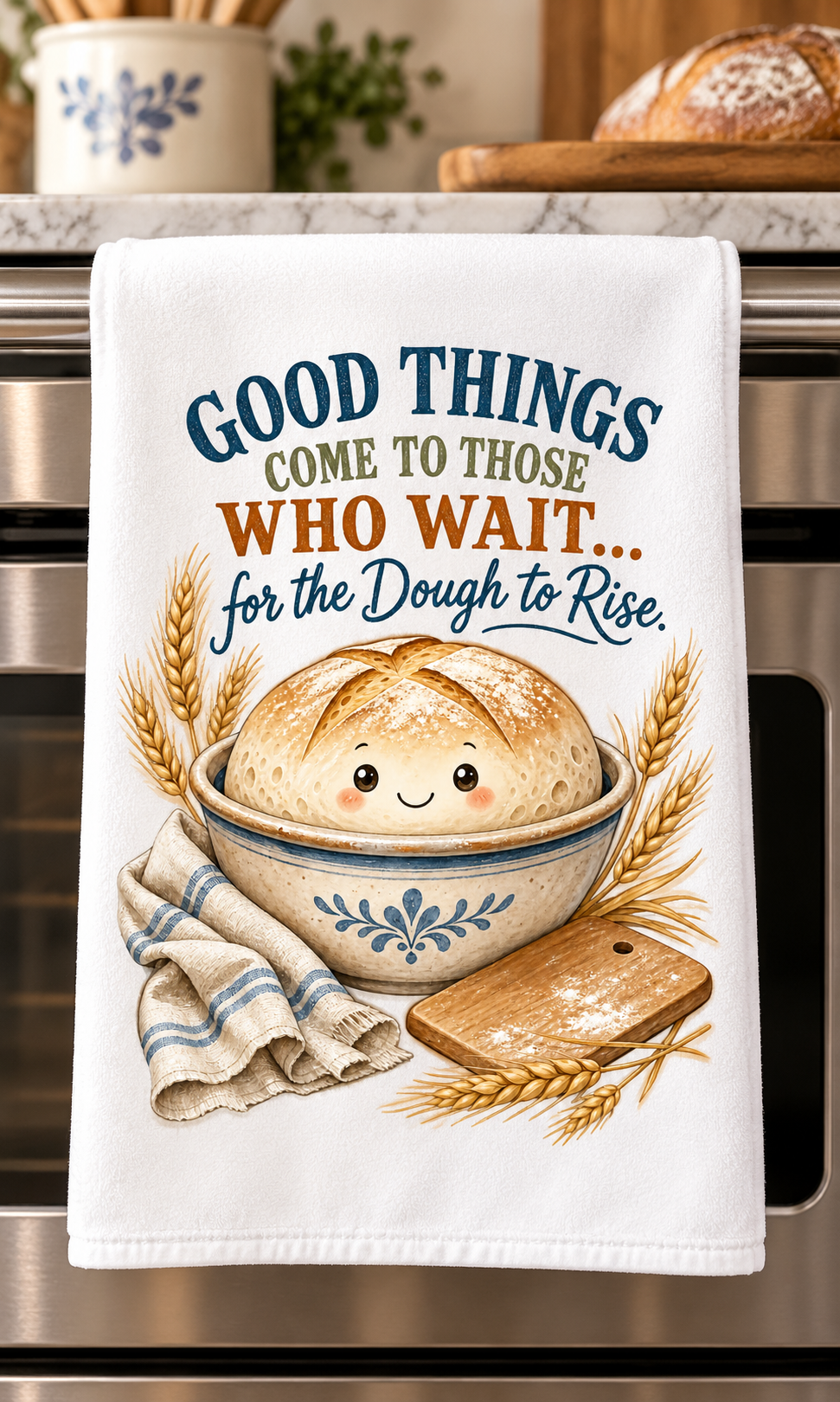 A white kitchen towel hanging on a stainless steel oven handle, printed with the phrase 'GOOD THINGS COME TO THOSE WHO WAIT.
