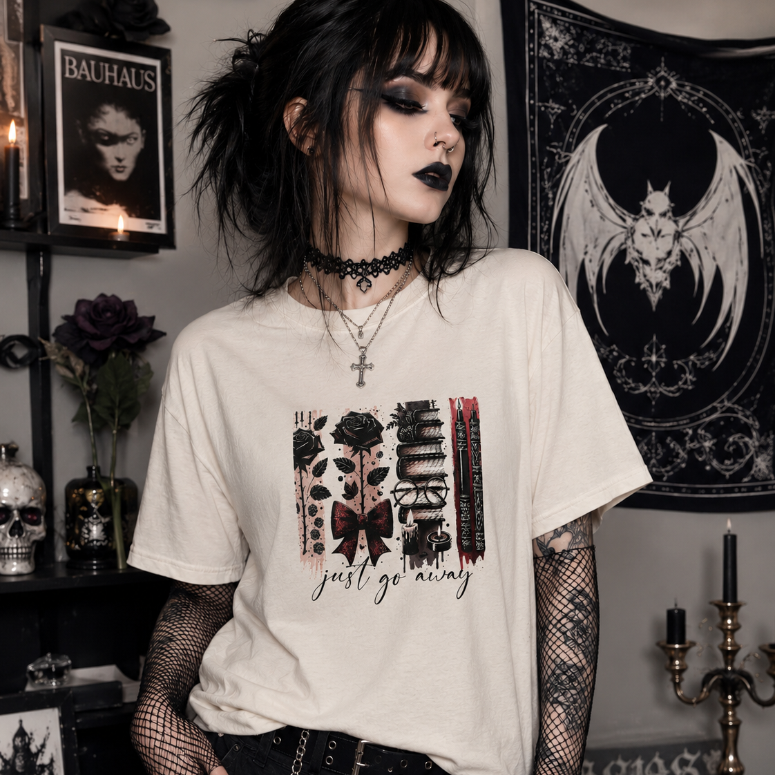 Person wearing a white t-shirt with graphic design in a dark, decoratively themed room.