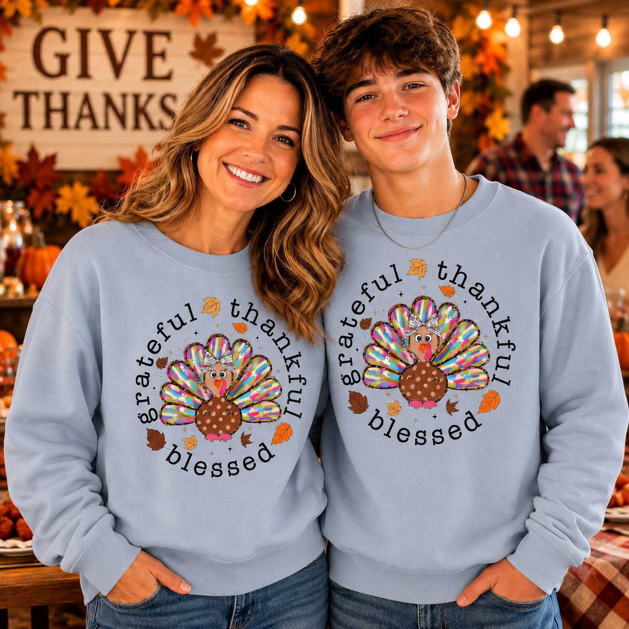 Mom and son wearing a light blue colored sweatshirt with text Grateful Thankful Blessed with a turkey graphic