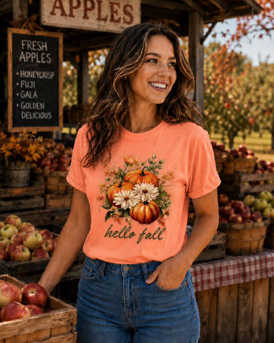 Woman wearing a 'hello fall' t-shirt at an apple orchard.