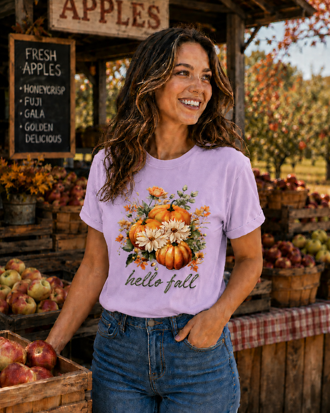 Woman wearing a 'hello fall' t-shirt at an apple orchard.