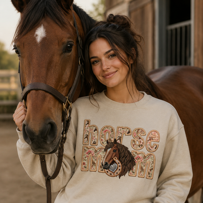 Woman wearing a 'horse mom' sand colored sweatshirt standing next to a horse.