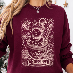 Cozy sweatshirt featuring a snowman soaking in a mug of hot chocolate, perfect for Christmas and holiday festivities.