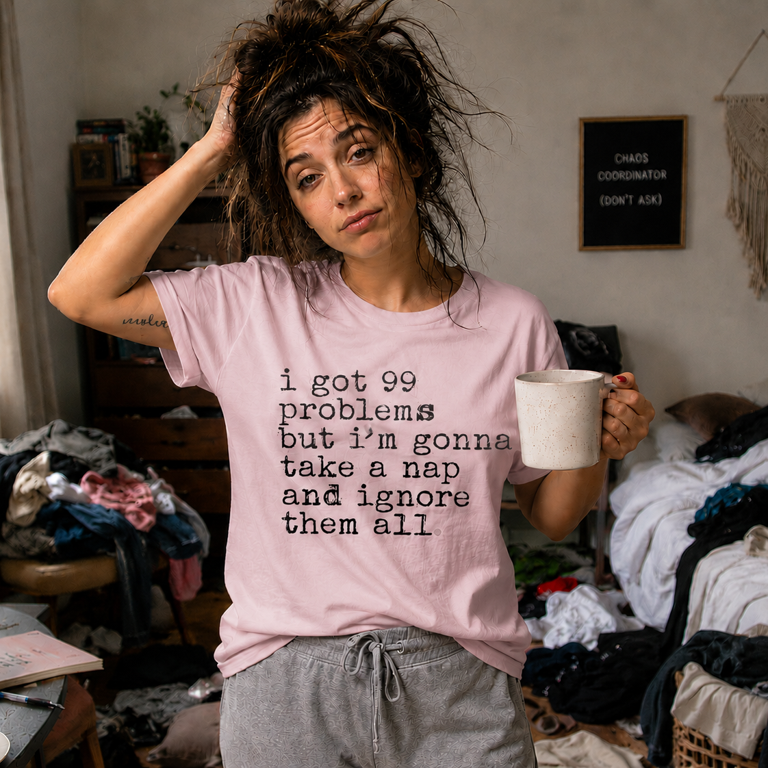 Person wearing a light pink colored t-shirt with I got 99 problems but I'm gonna take a nap and ignore it all