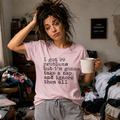 Person wearing a light pink colored t-shirt with I got 99 problems but I'm gonna take a nap and ignore it all