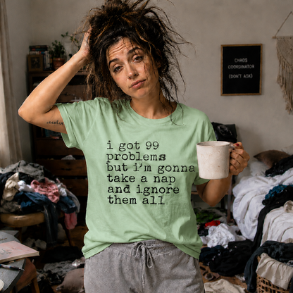 Person wearing a mint green colored t-shirt with I got 99 problems but I'm gonna take a nap and ignore it all