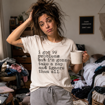 Person wearing a white colored t-shirt with I got 99 problems but I'm gonna take a nap and ignore it all