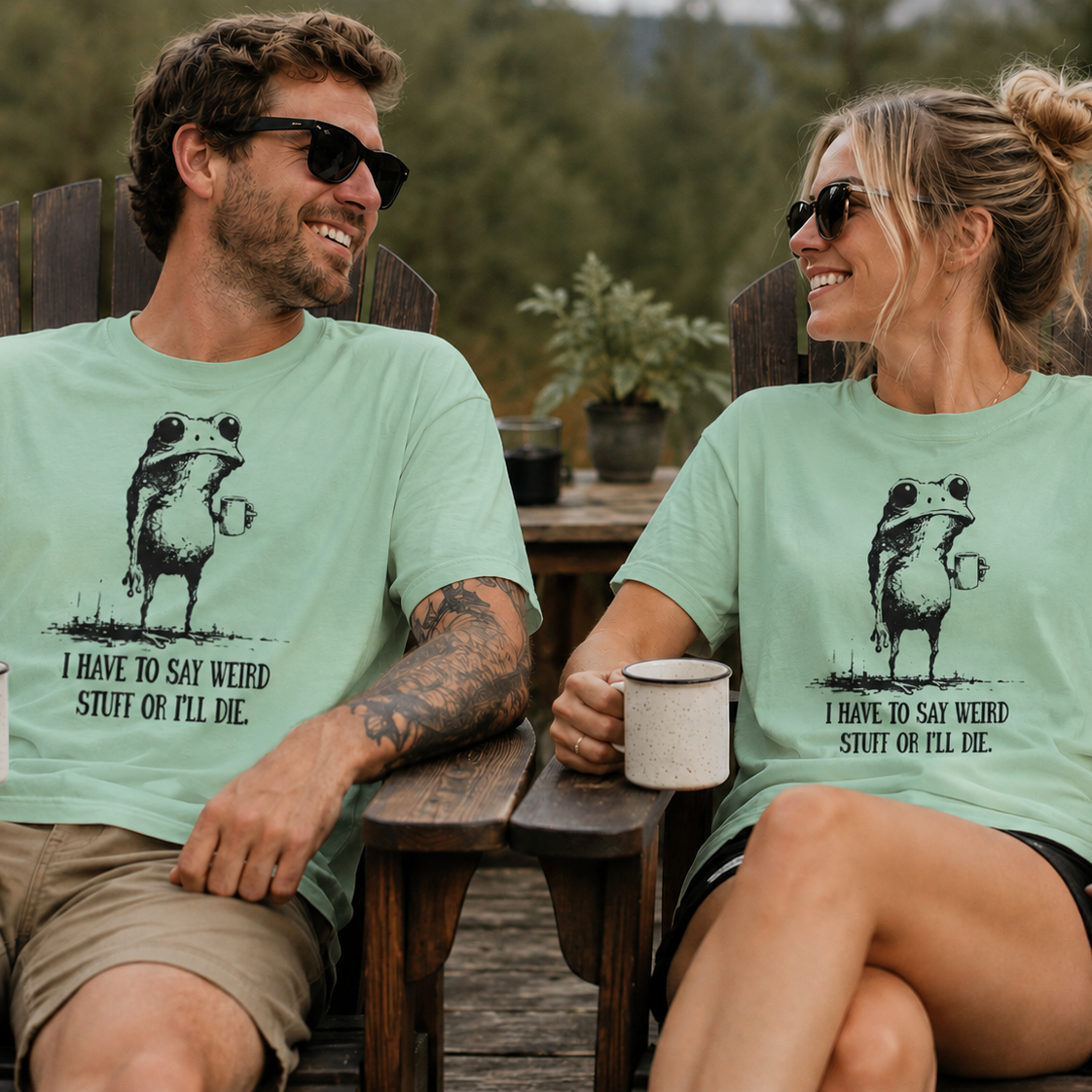 Two people sitting outdoors wearing matching mint green t-shirts with a graphic of a frog with humorous text