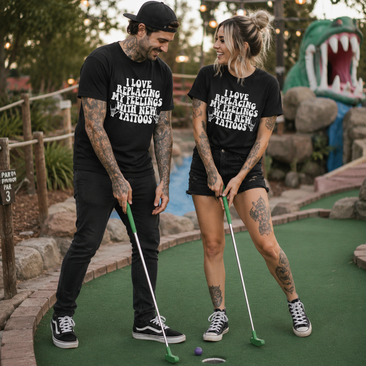 People wearing a black t-shirt with I love replacing my feelings with new tattoos white text design.