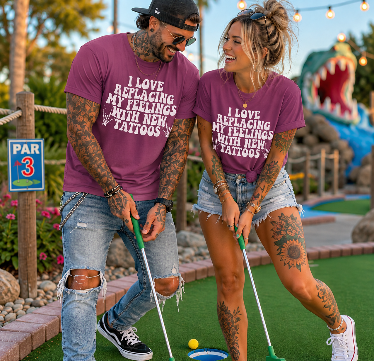 People wearing a heather berry colored  t-shirt with I love replacing my feelings with new tattoos white text design.