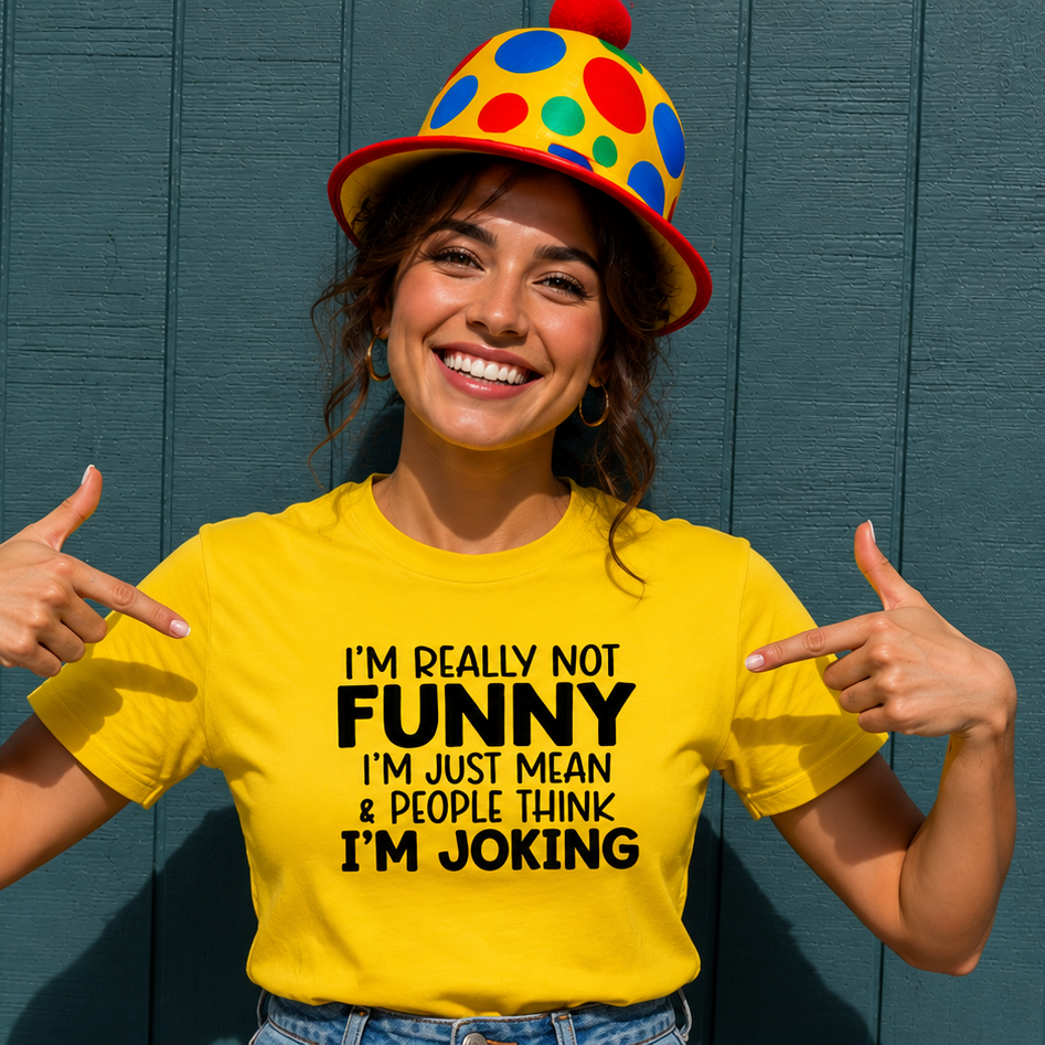 Person wearing a yellow t-shirt with humorous text and a colorful hat against a blue wall.