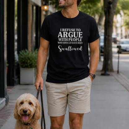Man walking a dog on a city street wearing a black t-shirt with a humorous message.