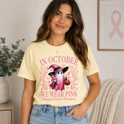 A girl wearing a banana colored t-shirt with a graphic design "In October we wear pink text with a ghost and pumpkin design
